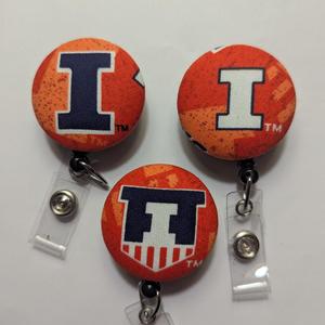 Illinois and Auburn badge reels