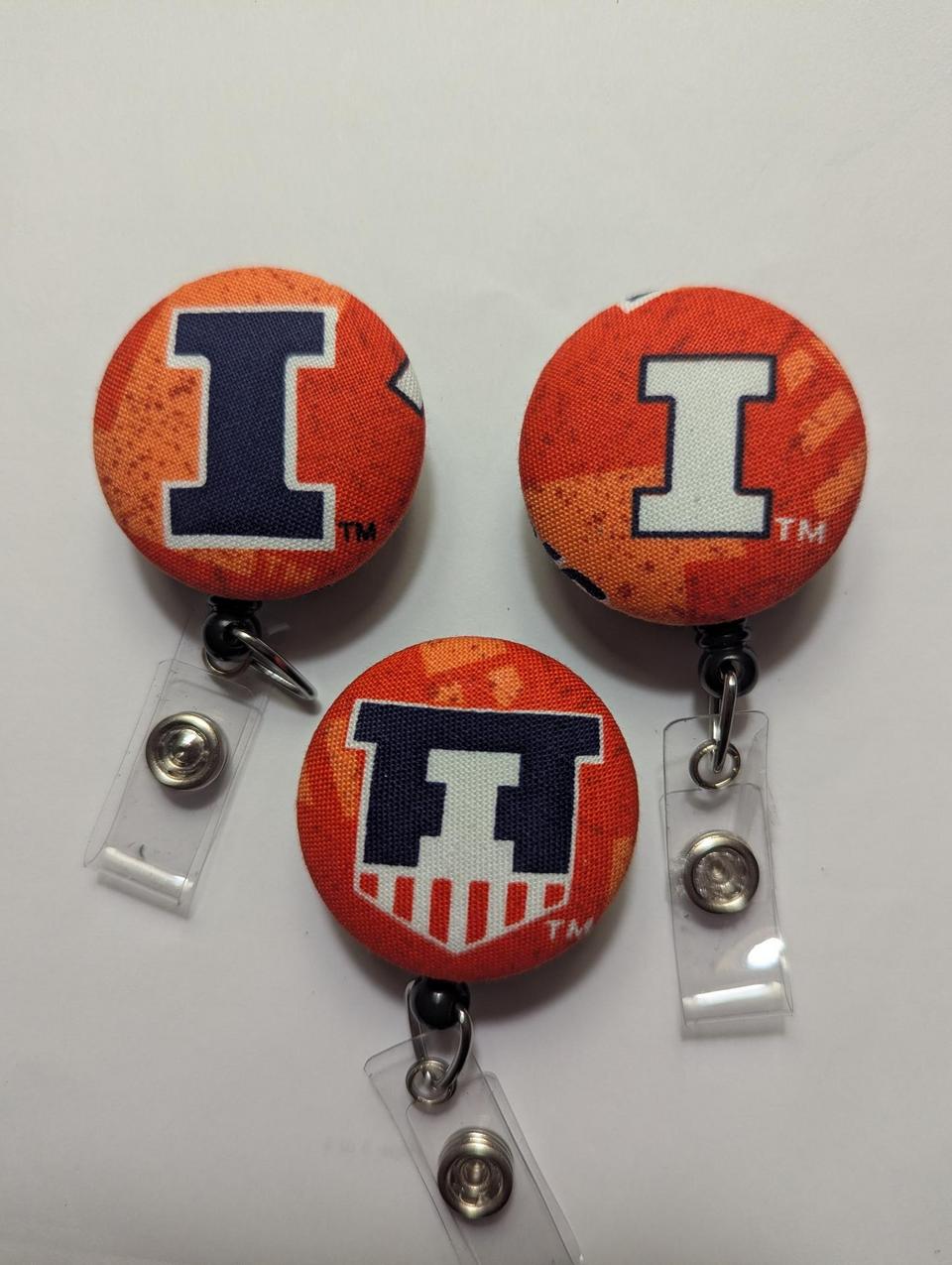 Illinois and Auburn badge reels